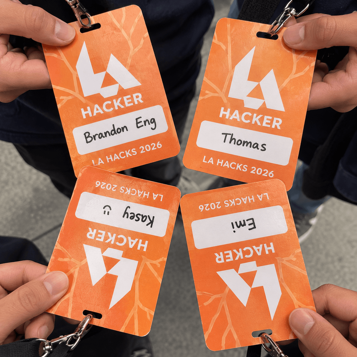 AI recreation of our LA Hacks 2026 badges for Brandon, Thomas, Kasey, and Emi