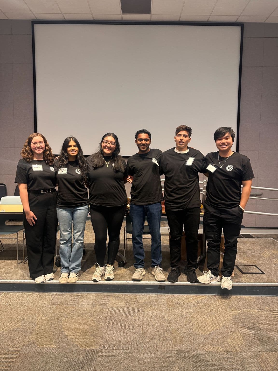 Six AI Summer Camp teammates standing together in a classroom